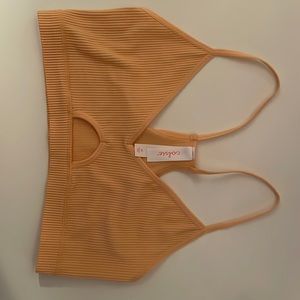 Light orange tank top. Medium but fits as s/m